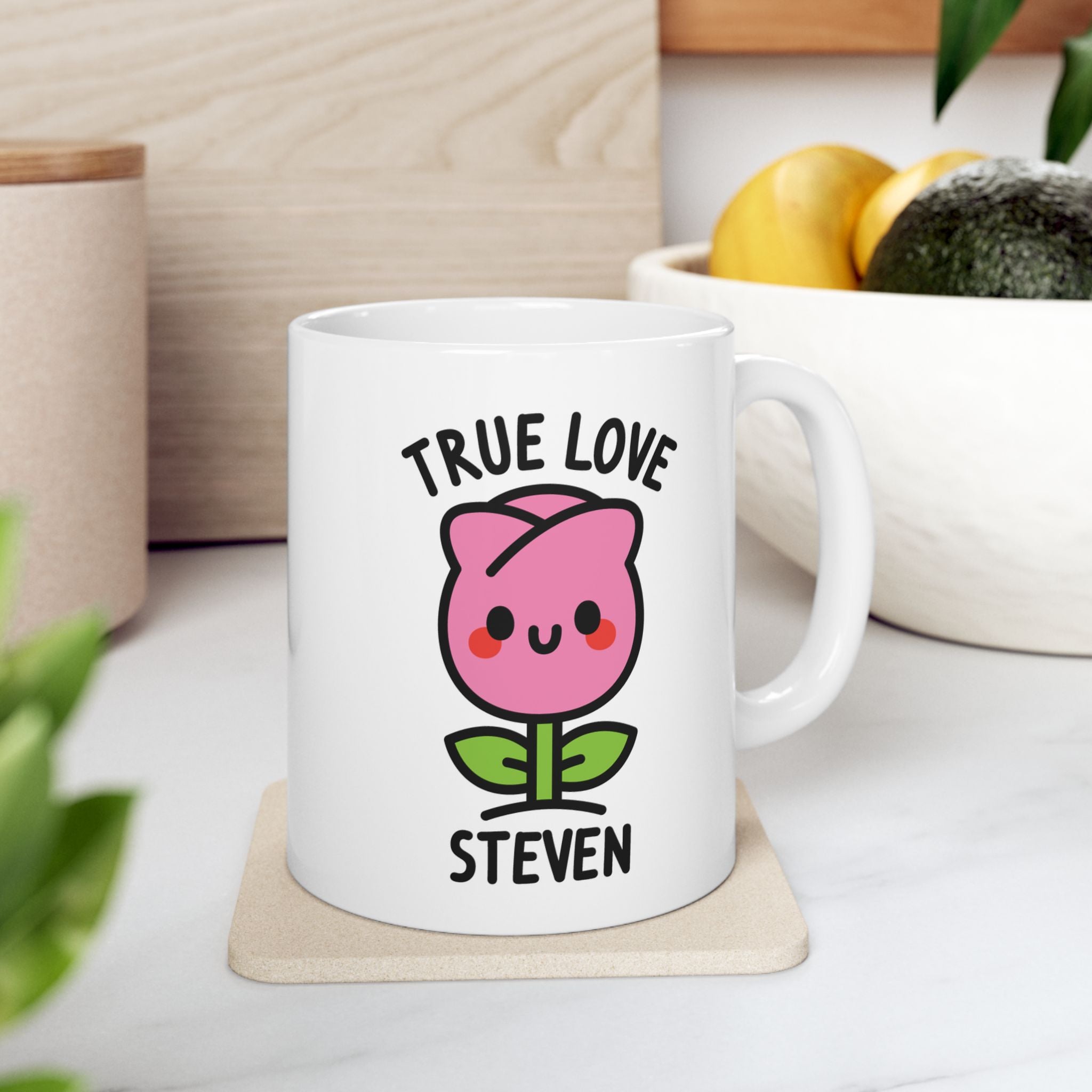 Cute Pink Rose Personalised Name Mug on coaster next to fruit bowl