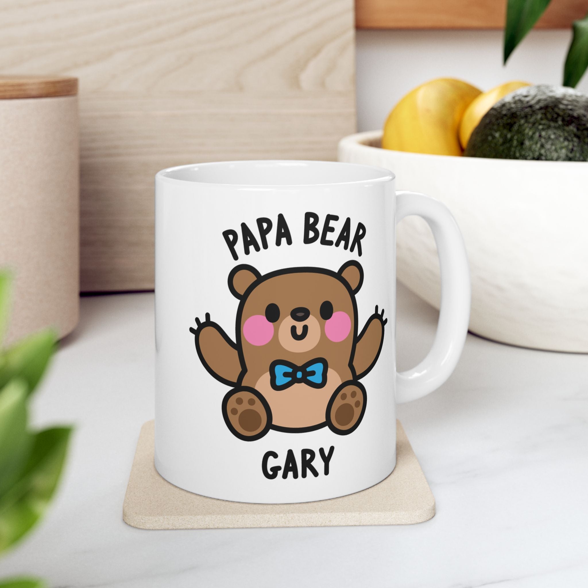 White mug with a cartoon bear design and text on a wooden surface.